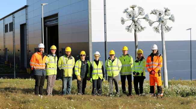 SSEN Transmission project team with representatives from Global Infrastructure and artist Ailsa Magnus (centre) outside the new Dundee warehouse