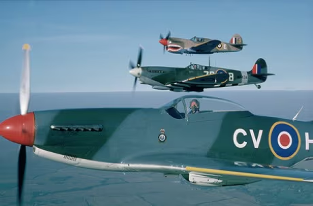 Three spitfire aircraft flying in formation